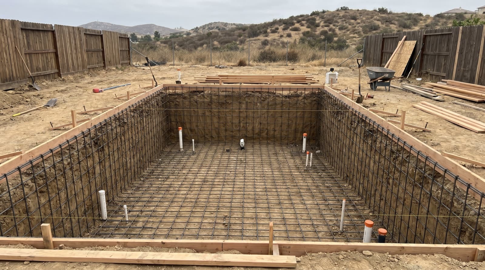 Excavation underway on a new inground pool in a Southern California backyard